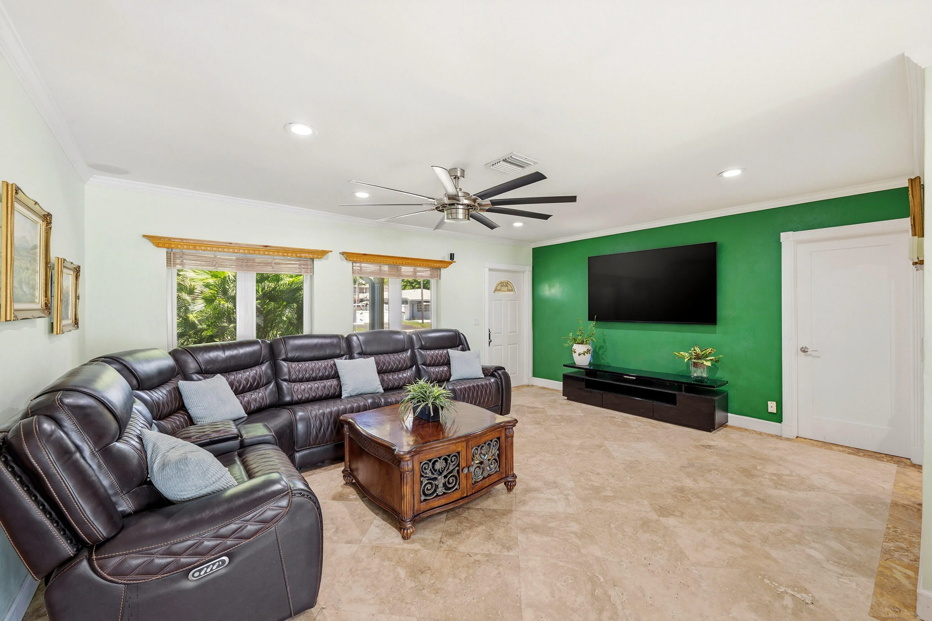 Your Living Room is Spacious & a Flexible Room. Impact Windows & Doors, LED Lighting and 18" Travertine Tile Floors 2025. Easy Access to Backyard, Kitchen and 2 Car Garage. Wall Mounted TV (Including Wall Mount) doesn't convey.