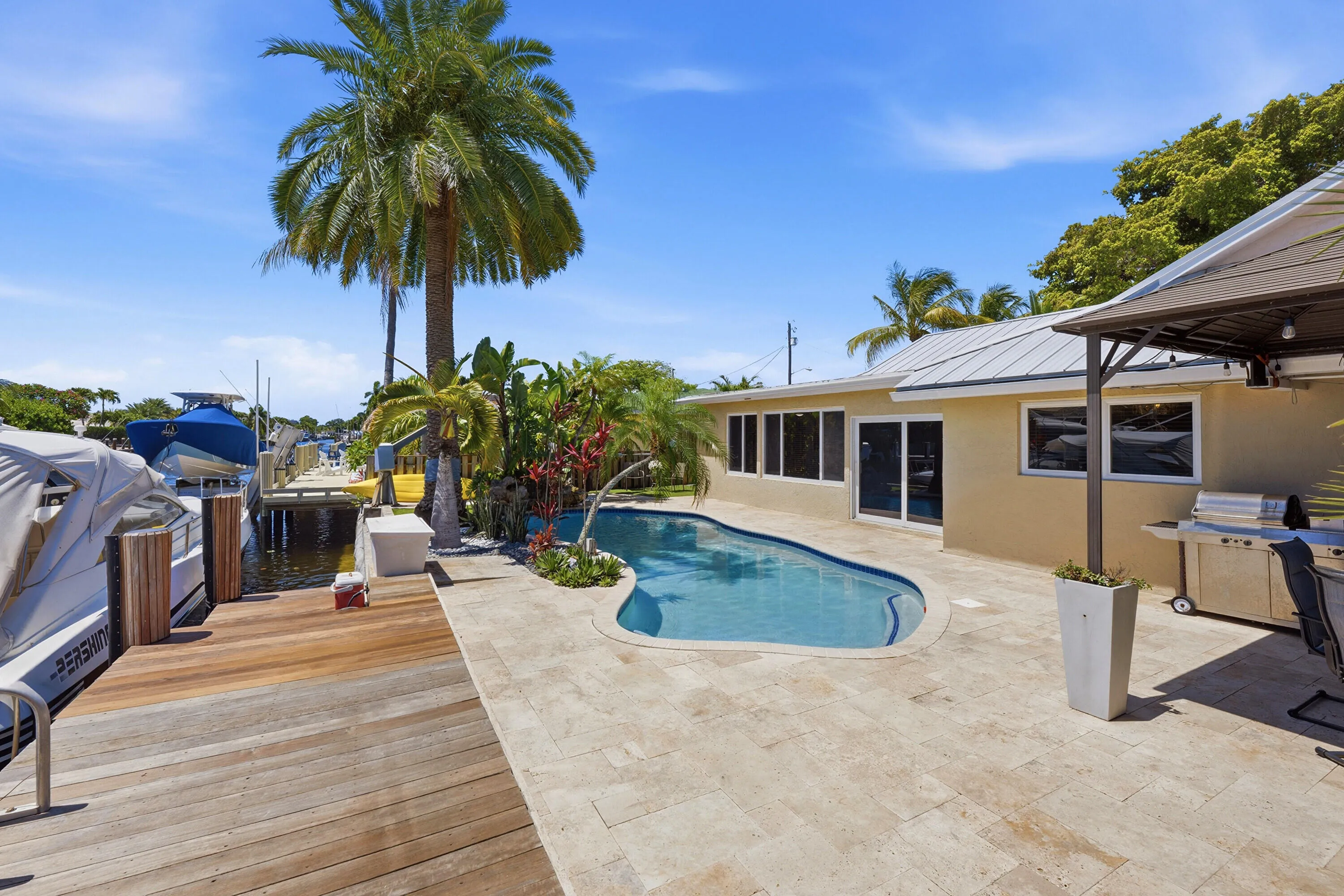 WOW! Your Ocean Access, Waterfront Lifestyle at it's Finest! 40' Dock, 70' Seawall, Freeform Pool with Rock Waterfall, Covered Patio Space for Fail Safe Outdoor Enteraining.