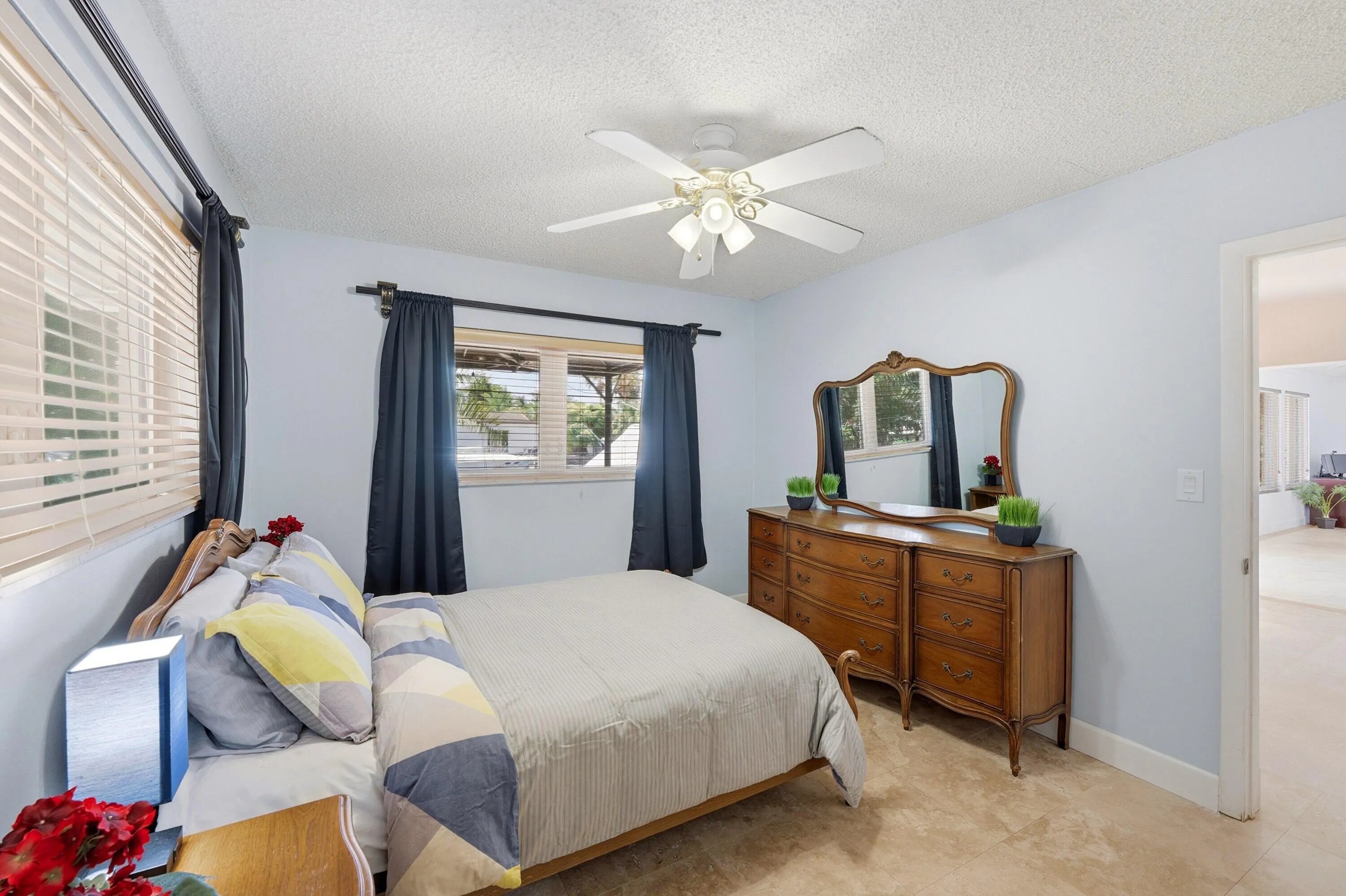 Guest Bedroom is Poolside with En-Suite Bathroom & Bright Walk-In Closet with Frosted Glass Doors.