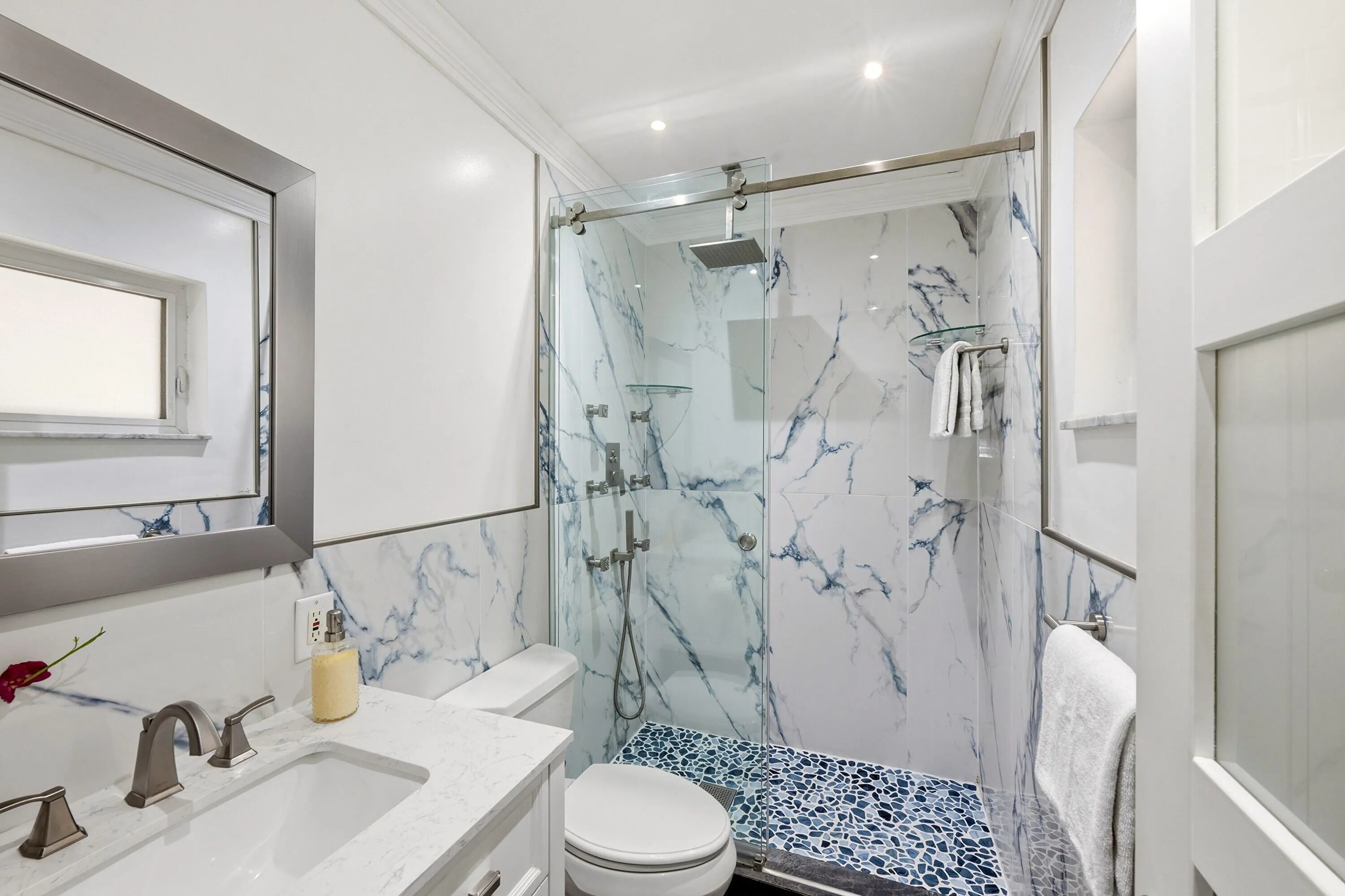 Guest Bathroom Updated 2025 with Glass Enclosed Shower and Frosted Glass Door and Window.