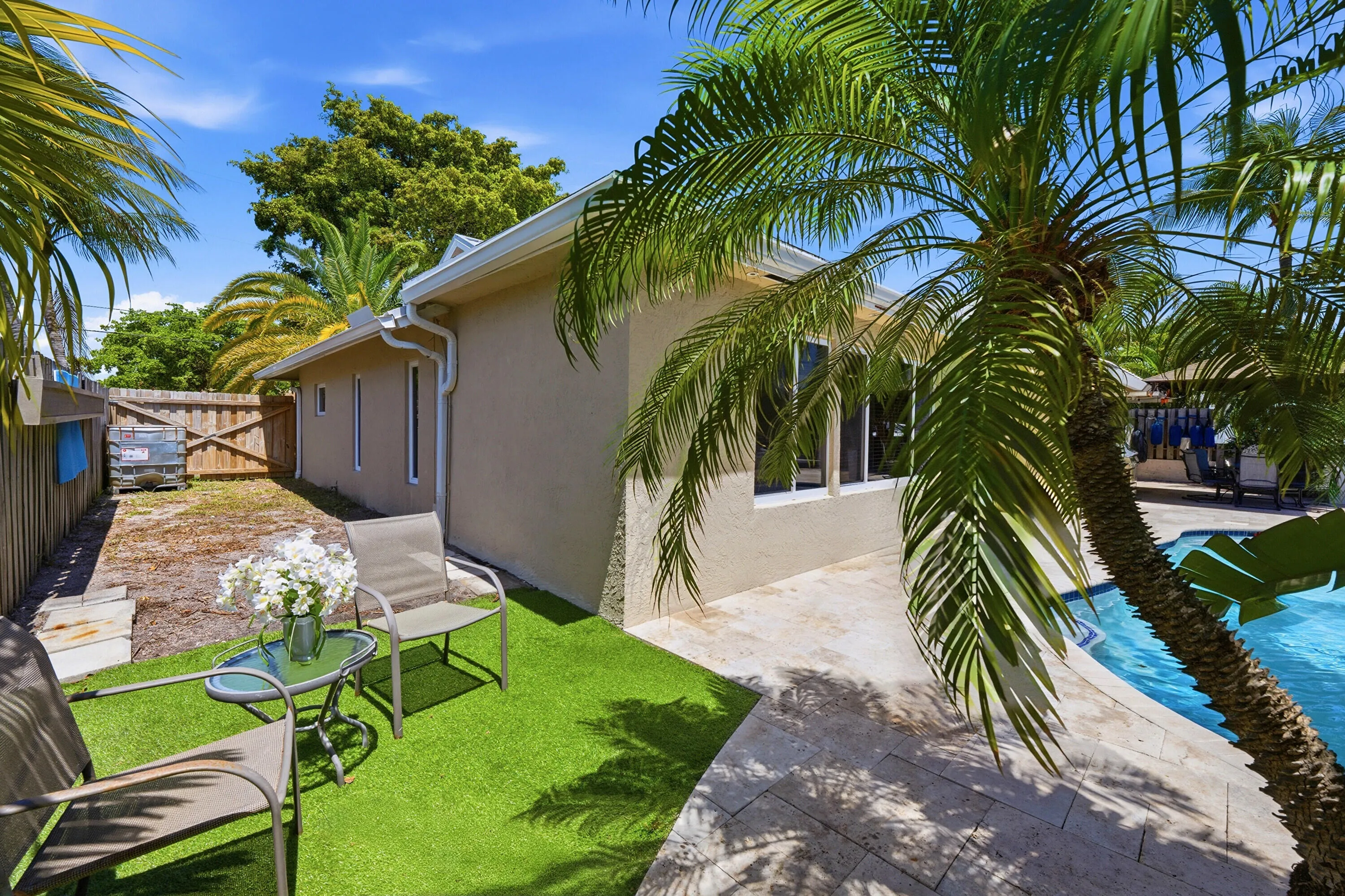 Tucked away next to your Poop and Rock Waterfall is a Lounge Oasis as well as a HUGE Side Yard for all needs, the Fence has a Wide Gate in the Front for Easy Access.