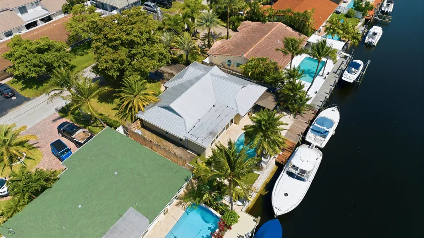 Aerial of the 40' Dock, 70' Seawall, Freeform Pool with Rock Waterfall, Covered Patio Space for Fail Safe Outdoor Patio Perfect for Enteraining. Your Ocean Access, Waterfront Lifestyle at it's Finest!