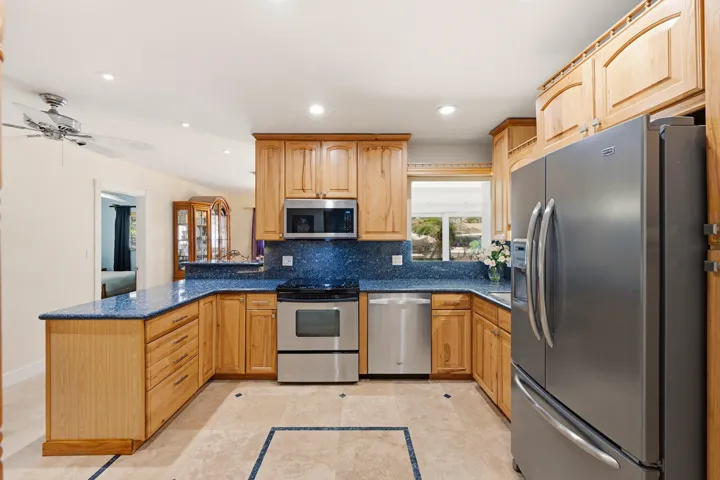 Your HUGE Kitchen includes SS Appliances, Tall Custome Cabinets with Crown Molding, LED Lighting, 18" Travertine Tile Floors, Granite Countertops, 2 Snack Bars with a Pass-Thru for Convenience.