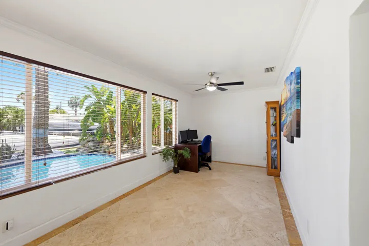 East Facing Florida Room Looks Over the Backyard, Pool, Rock Waterfall, Covered Patio, 40'Dock, 70' Seawall & Ocean Access.