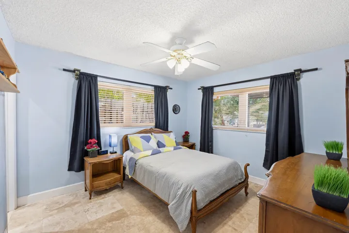 Guest Bedroom is Poolside with En-Suite Bathroom & Bright Walk-In Closet with Frosted Glass Doors.