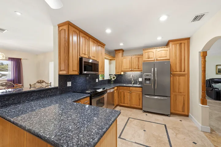Your HUGE Kitchen includes SS Appliances, Tall Custome Cabinets with Crown Molding, LED Lighting, 18" Travertine Tile Floors, Granite Countertops, 2 Snack Bars with a Pass-Thru for Convenience.