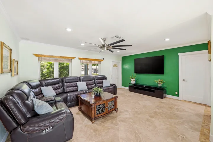 Your Living Room is Spacious & a Flexible Room. Impact Windows & Doors, LED Lighting and 18" Travertine Tile Floors 2025. Easy Access to Backyard, Kitchen and 2 Car Garage. Wall Mounted TV (Including Wall Mount) doesn't convey.