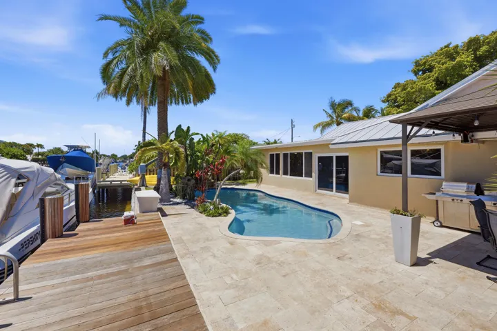 WOW! Your Ocean Access, Waterfront Lifestyle at it's Finest! 40' Dock, 70' Seawall, Freeform Pool with Rock Waterfall, Covered Patio Space for Fail Safe Outdoor Enteraining.