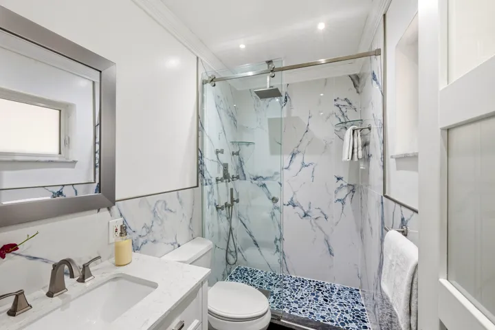 Guest Bathroom Updated 2025 with Glass Enclosed Shower and Frosted Glass Door and Window.