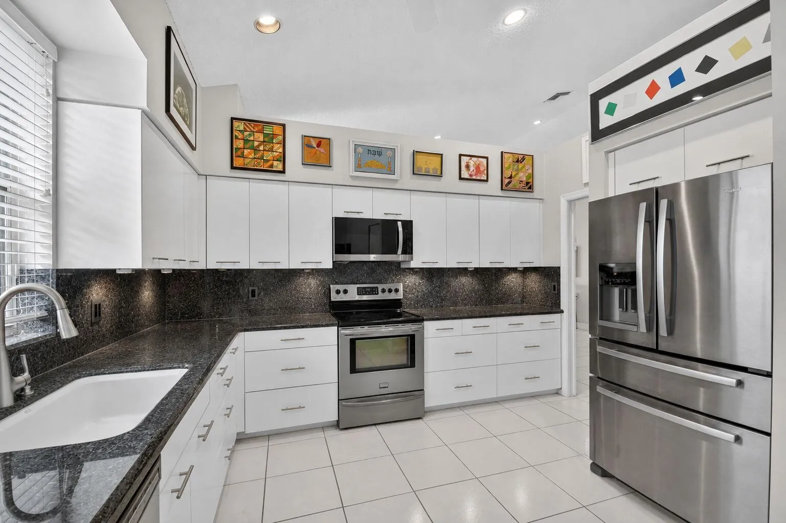 Kitchen with Stainless Steel Appliances and black granite countertops