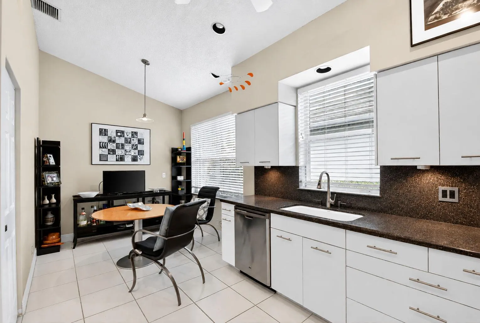 Kitchen with breakfast nook and multiple windows which proved lots of daylight