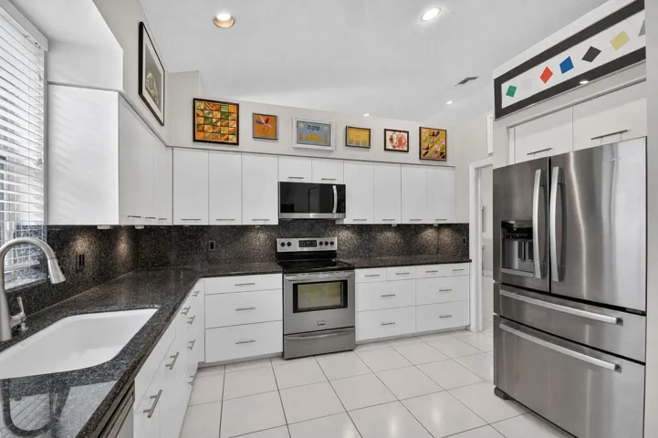 Kitchen with Stainless Steel Appliances and black granite countertops