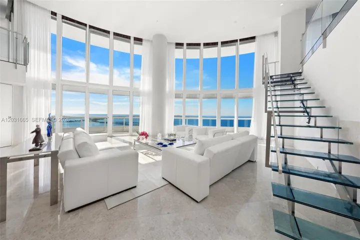 Living Room with custom designed glass and stainless steel staircase