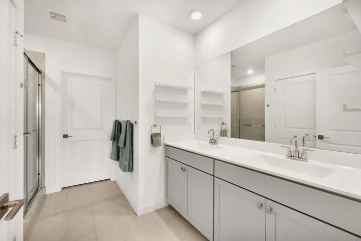 Primary Bathroom with dual sinks and full shower
