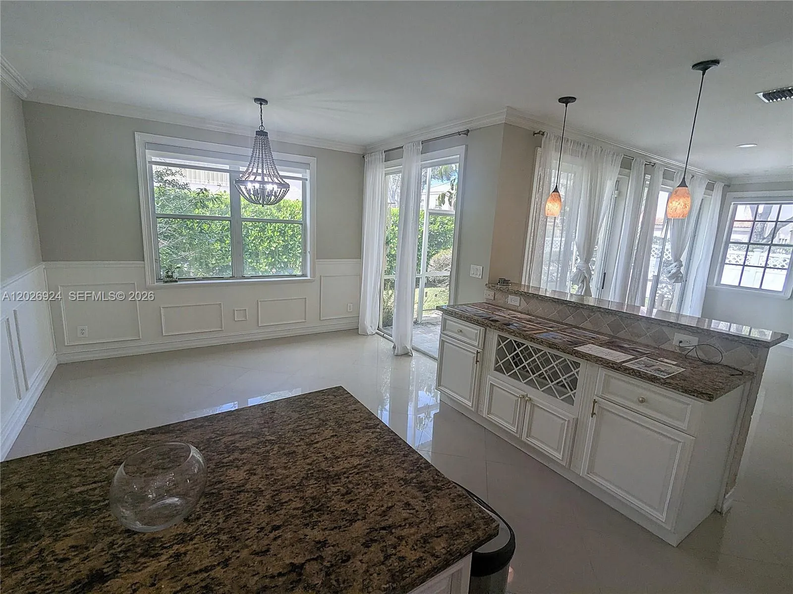 Dining area and counter bar flooded with natural light, offering a bright, open atmosphere — an inviting canvas ready for your creative signature