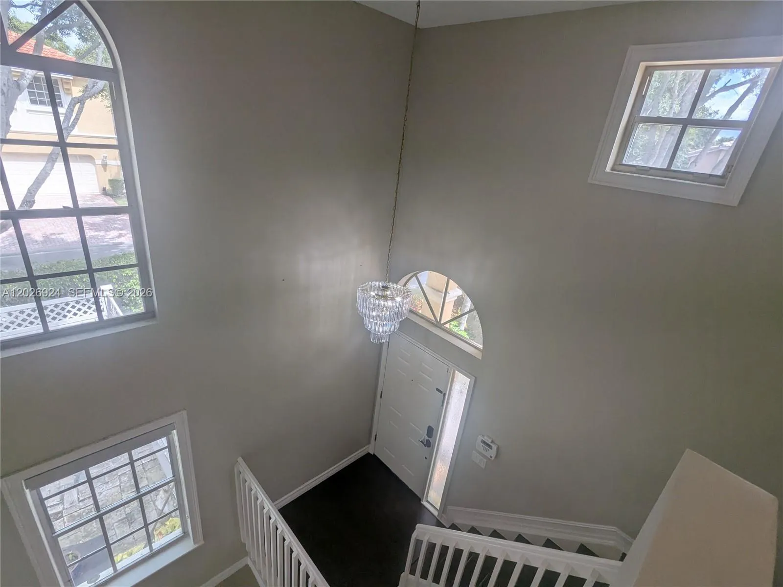 The double-height foyer, beautifully highlighted by the clarity of natural light, creates a grand and luminous entrance — ready for you to add your personal style