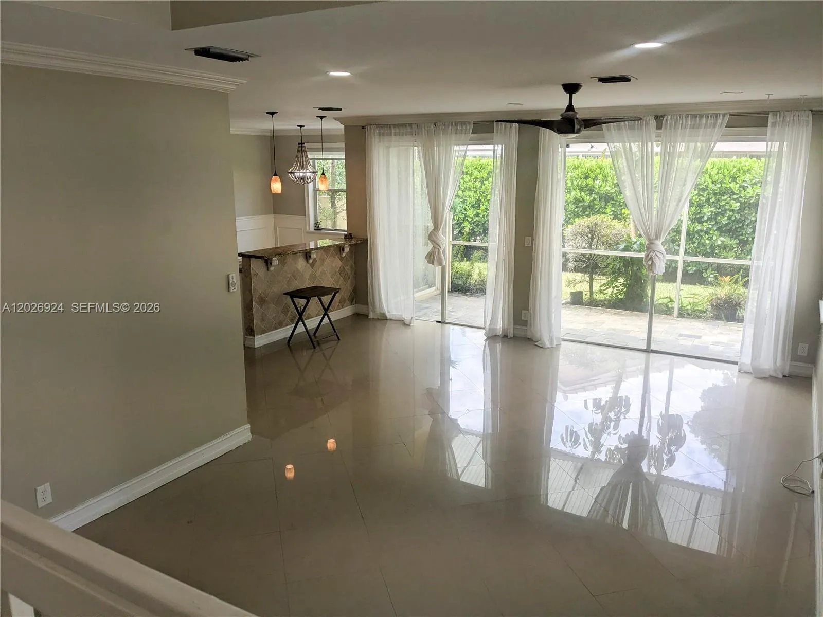 A bright space, filled with natural light pouring in through the sliding doors and windows — a true blank canvas ready for your creativity