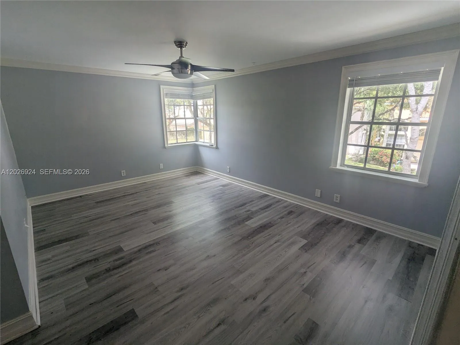 Grand primary bedroom, fully illuminated by three single-hung windows, creating a bright and serene atmosphere — the perfect setting for your private space