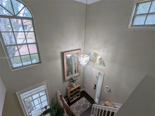 Stunning two-story foyer with abundant natural light, a crystal chandelier, and a welcoming entry that sets the tone for the home’s refined design.
