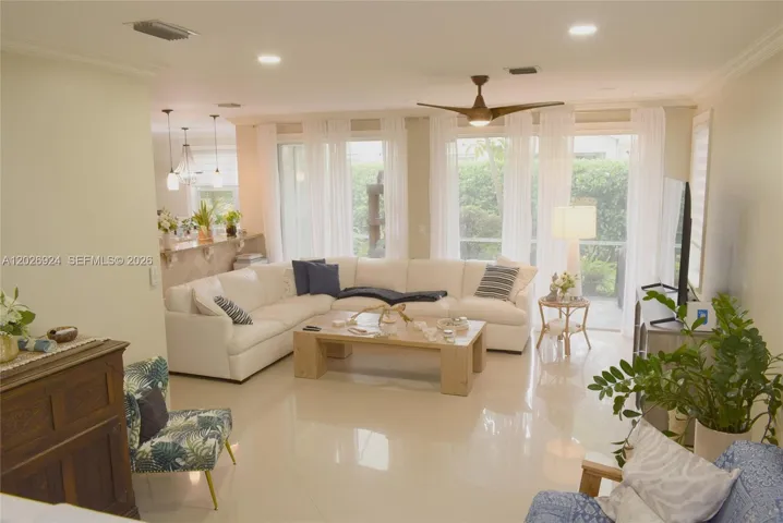 Bright and inviting living area with plenty of space for a receiving plus formal living room, abundant natural light, and a seamless connection to the outdoor greenery—perfect for relaxing or entertaining.