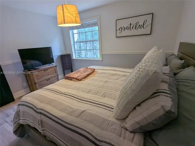 Second bedroom featuring a comfortable layout, soft natural light, and a spacious walk-in closet, offering a practical and inviting space for everyday living.