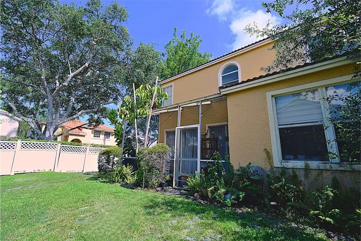 Private, well-kept backyard with lush greenery and tall hedges that create a peaceful, secluded outdoor space