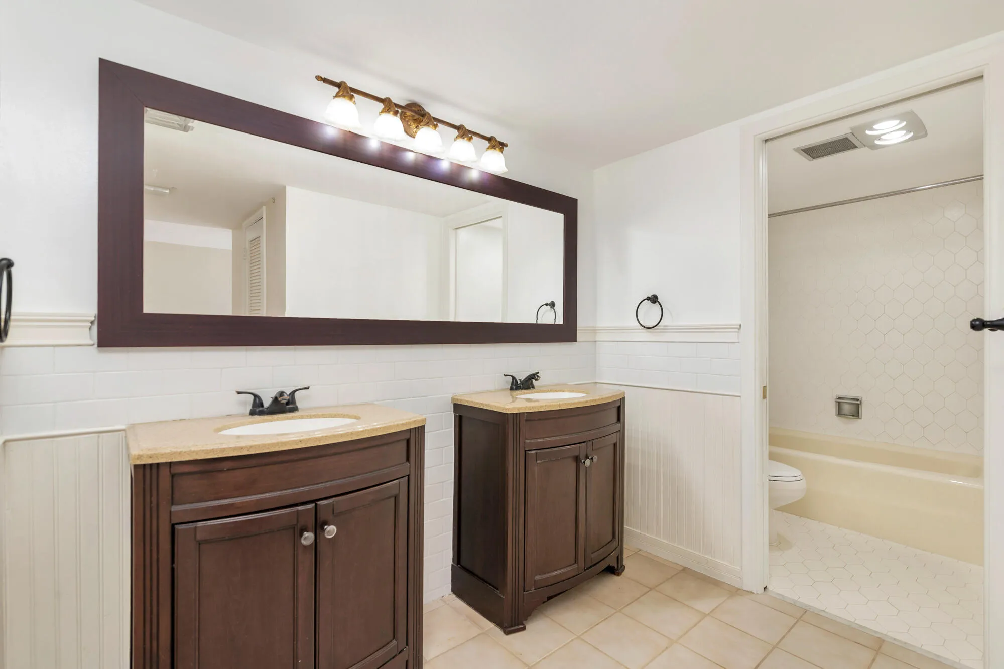 Primary Bathroom with dual sink and shower/tub​​‌​​​​‌​​‌‌​‌‌​​​‌‌​‌​‌​‌​​​‌​​ combo