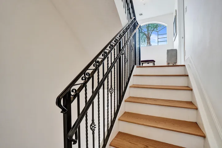 Architectural details throughout, oak wood stairway, wrought Iron railings, arched window