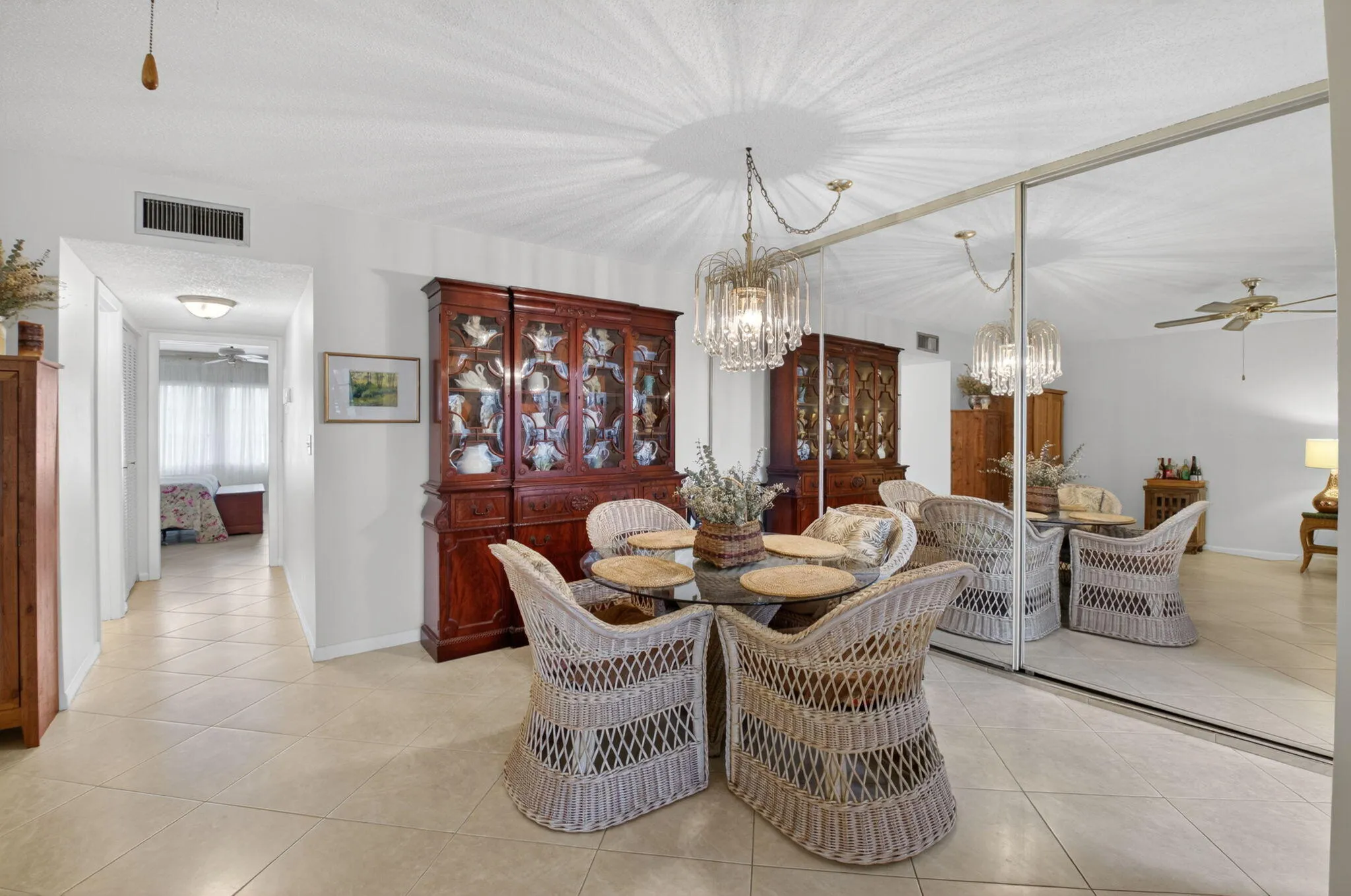 Dining room with floor to ceiling storage behind mirrored sliding doors