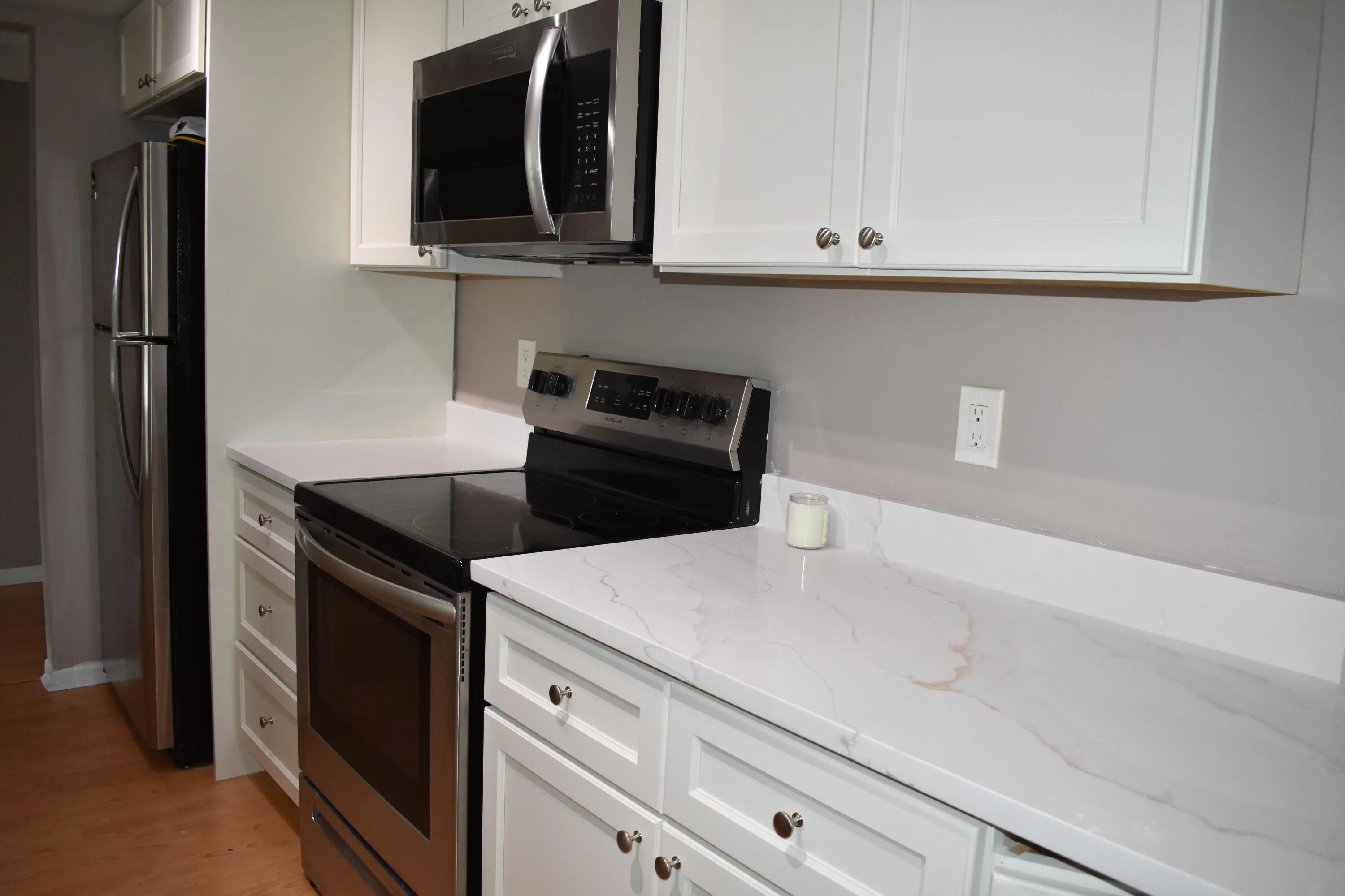 White cabinets with white quartz countertops in kitchen