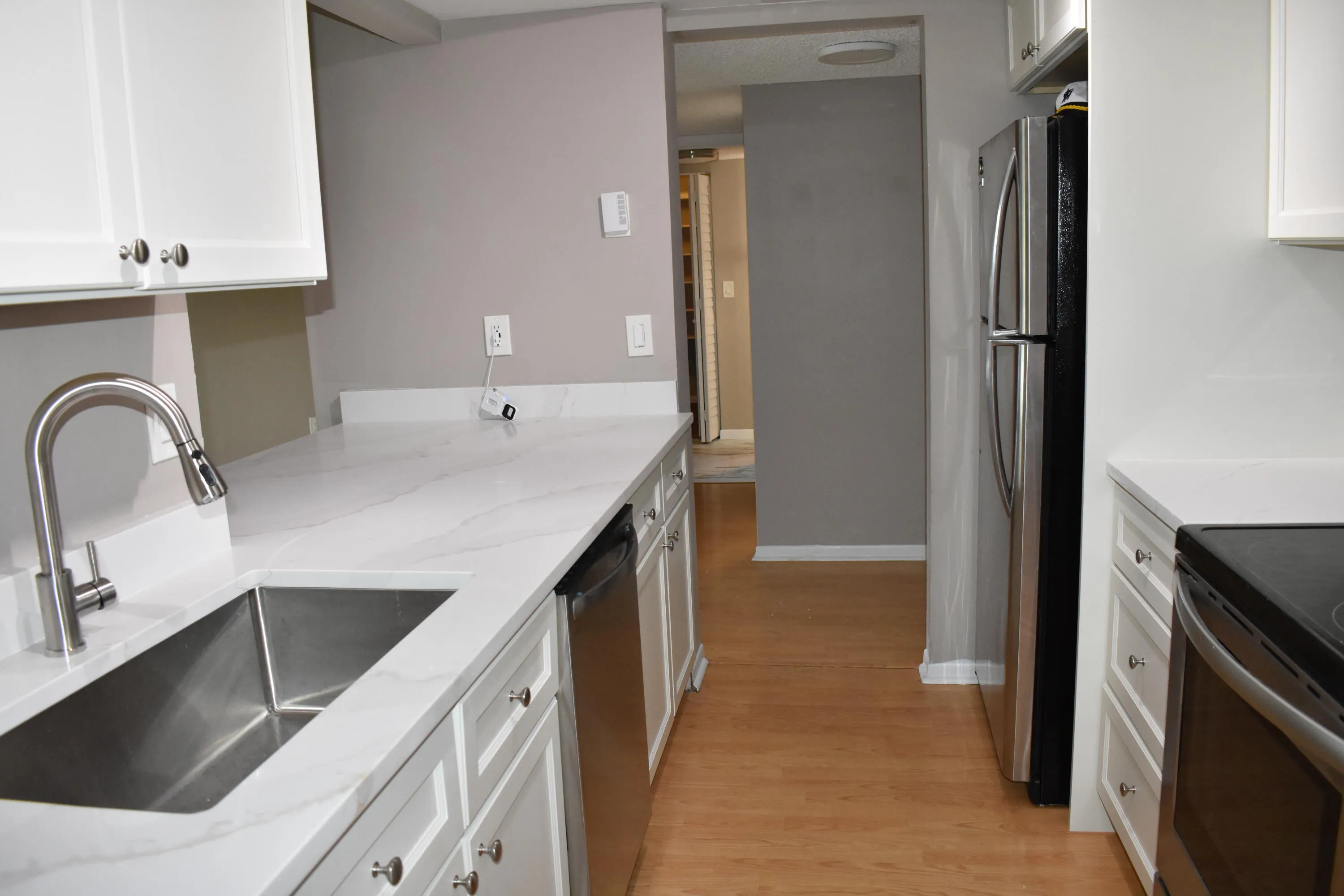 White cabinets with white quartz countertops in kitchen
