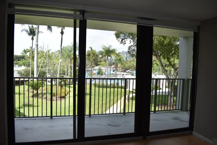 Living room view of pool, city and canal from new impact sliding glass doors