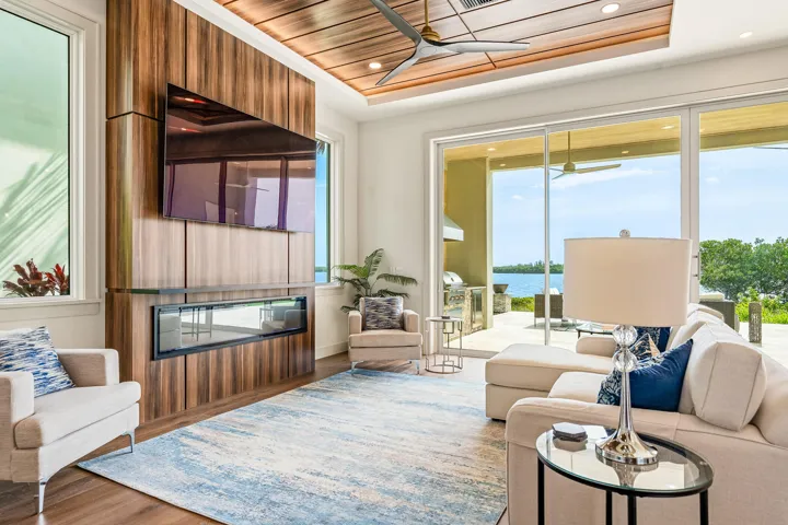 Spacious living area with custom fireplace & wide water views.
