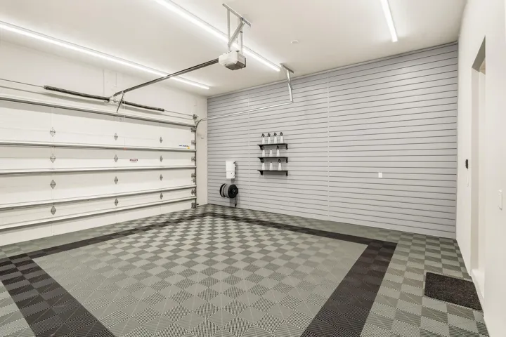 Expertly finished by Obsessed Garage, featuring premium SwissTrax floors, custom PVC slat-wall storage, and an integrated, built-in vacuum system.