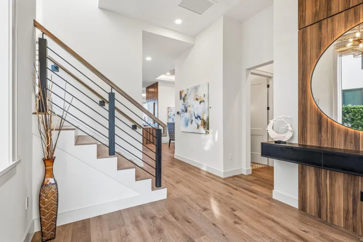 Beautiful foyer with built - in floating console & custom illuminated mirror