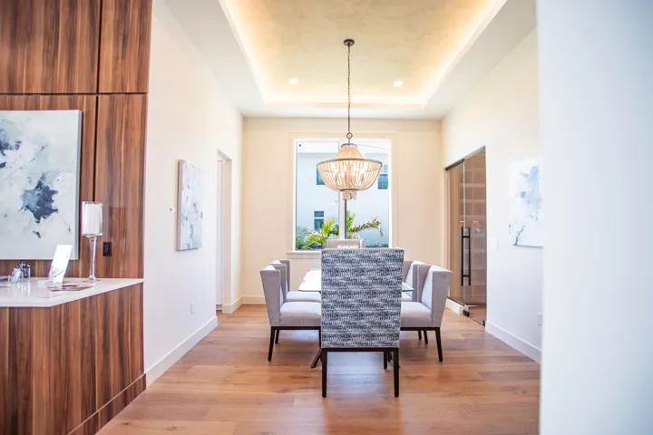 Beautiful dining room with custom lighted tray ceilings featuring Venetian plaster finish.