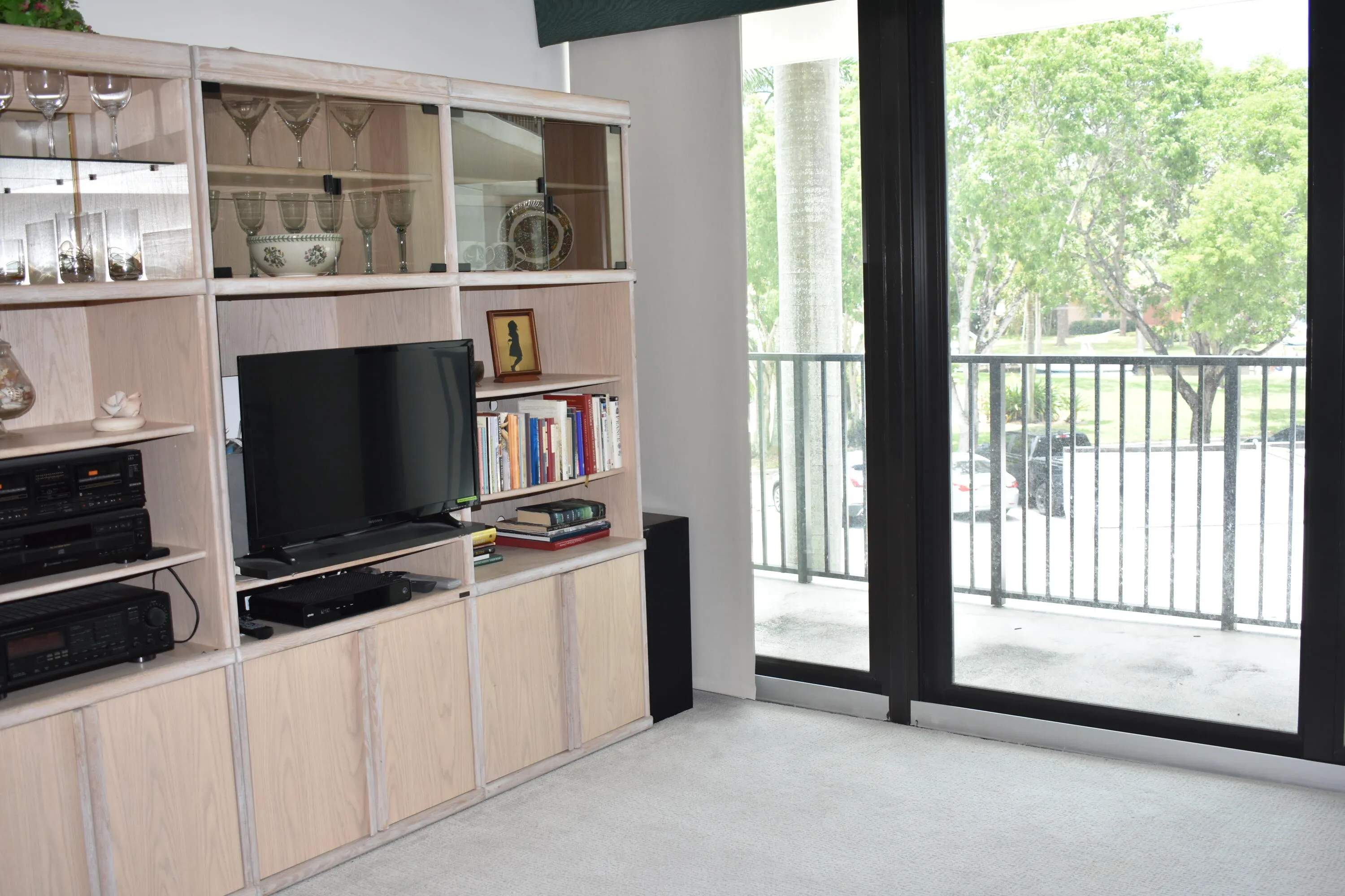 Living room with new impact sliding glass doors to balcony