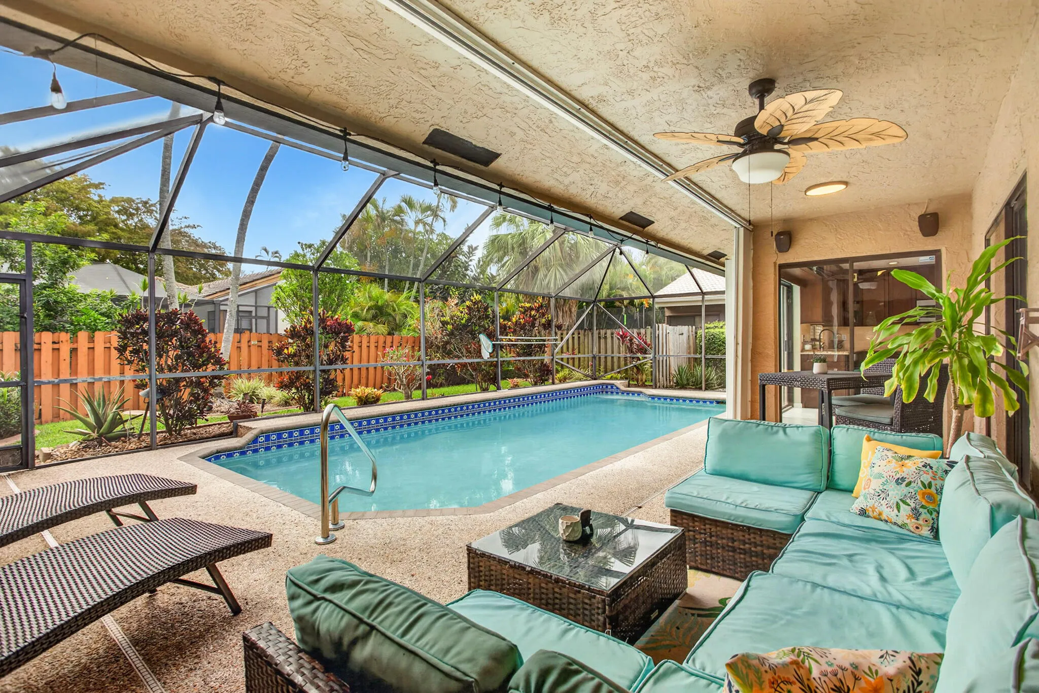 Covered and screened, this backyard patio is perfect for entertaining.