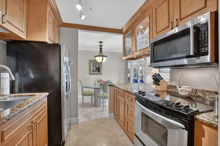 Custom wood cabinetry, granite counters and stainless steel appliances