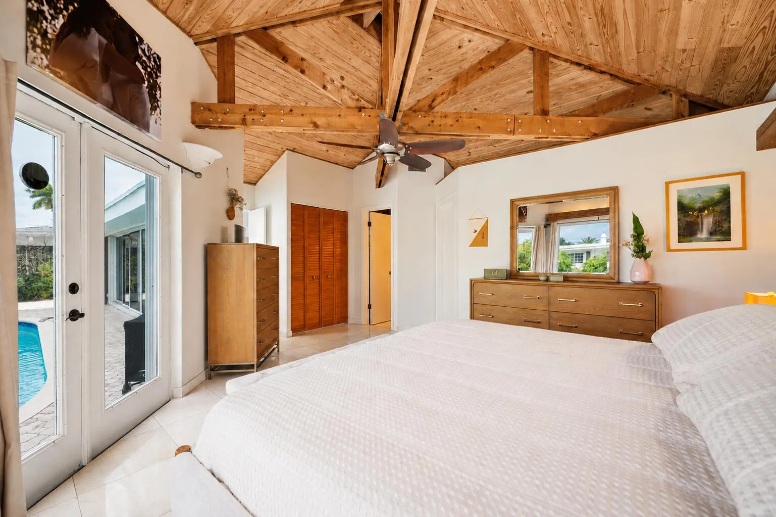 Primary suite steps to the pool and open patio.