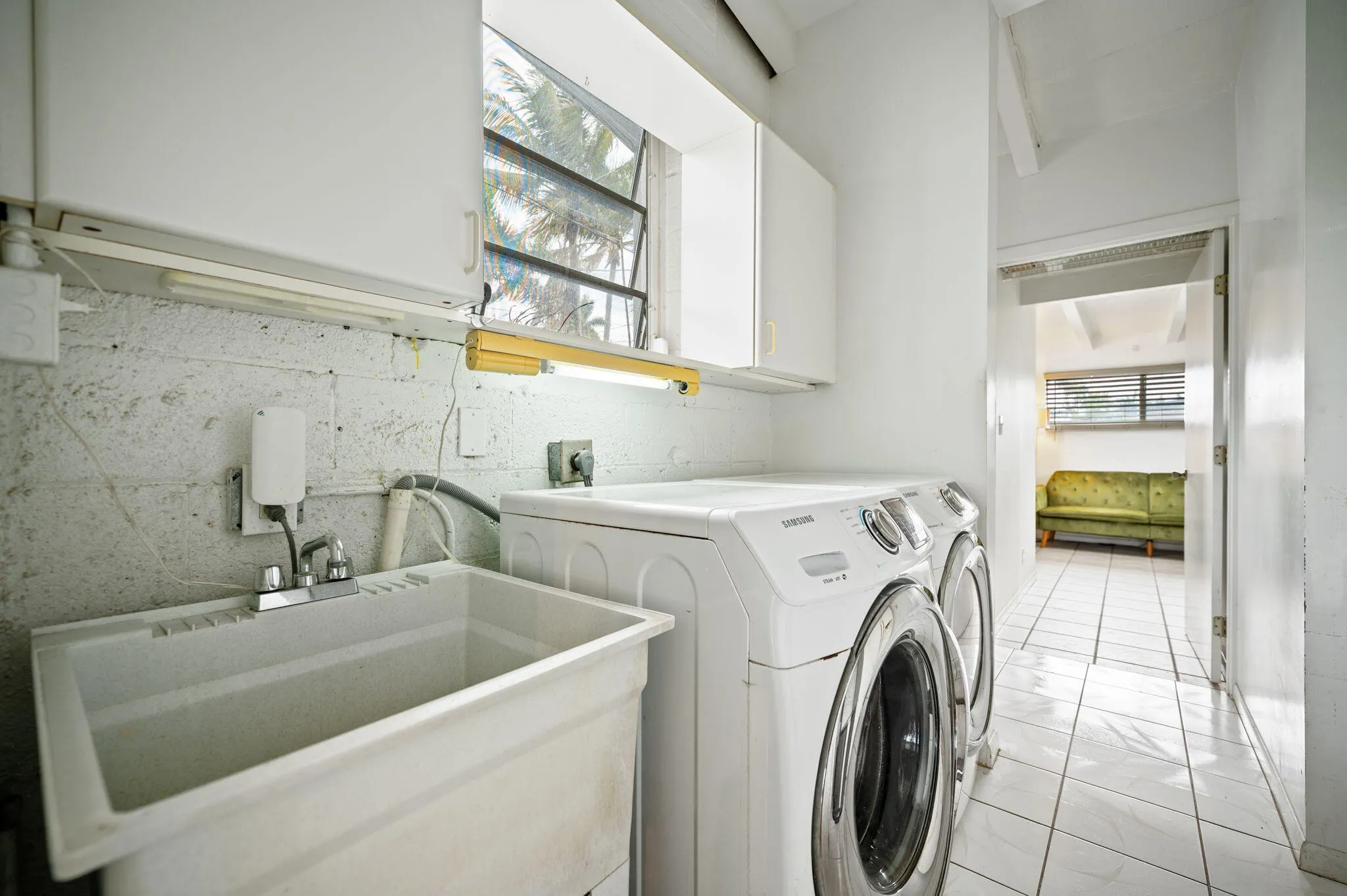 Laundry room with laundry tub and entry to 4th bedroom ensuite with separate entrance