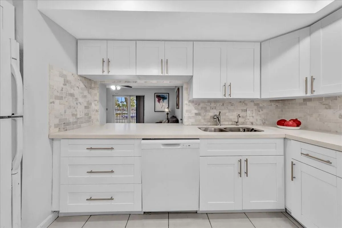 open-concept kitchen, breakfast pass-through, Fort Lauderdale condo for sale, coastal style kitchen, stainless sink, natural light kitchen, ocean area condo living