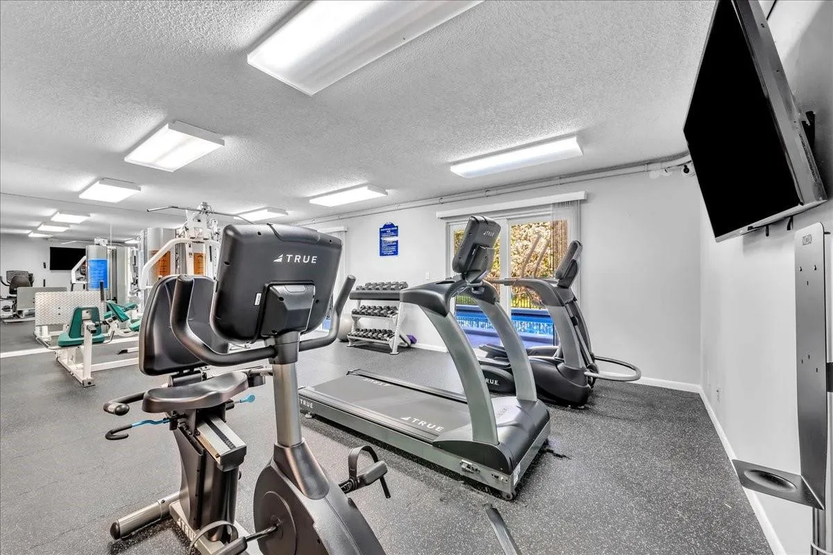 Bright gym with treadmills, bikes, and weights at Top of the Mile condos Fort Lauderdale.