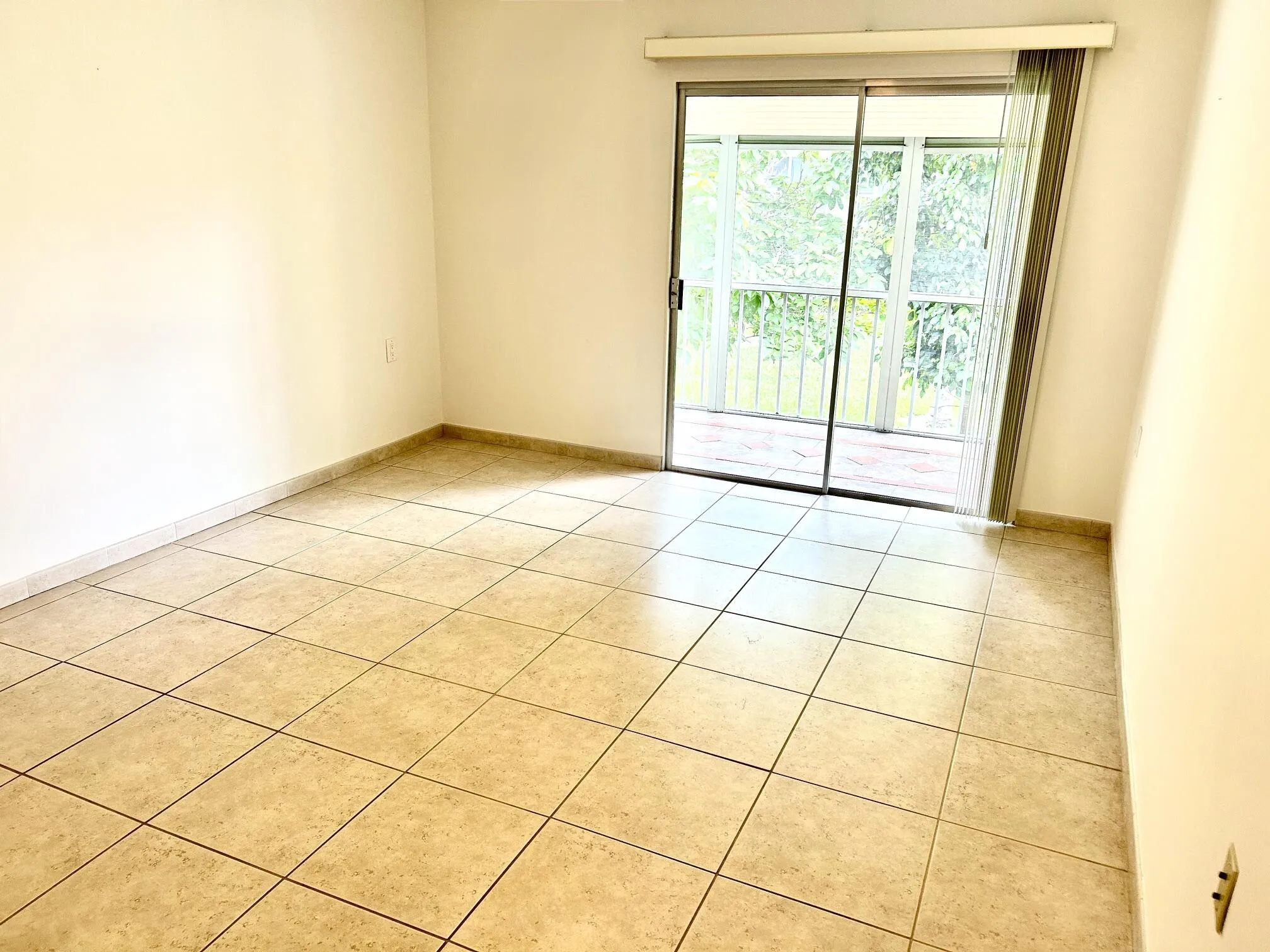 Primary bedroom with sliders to the screened patio.