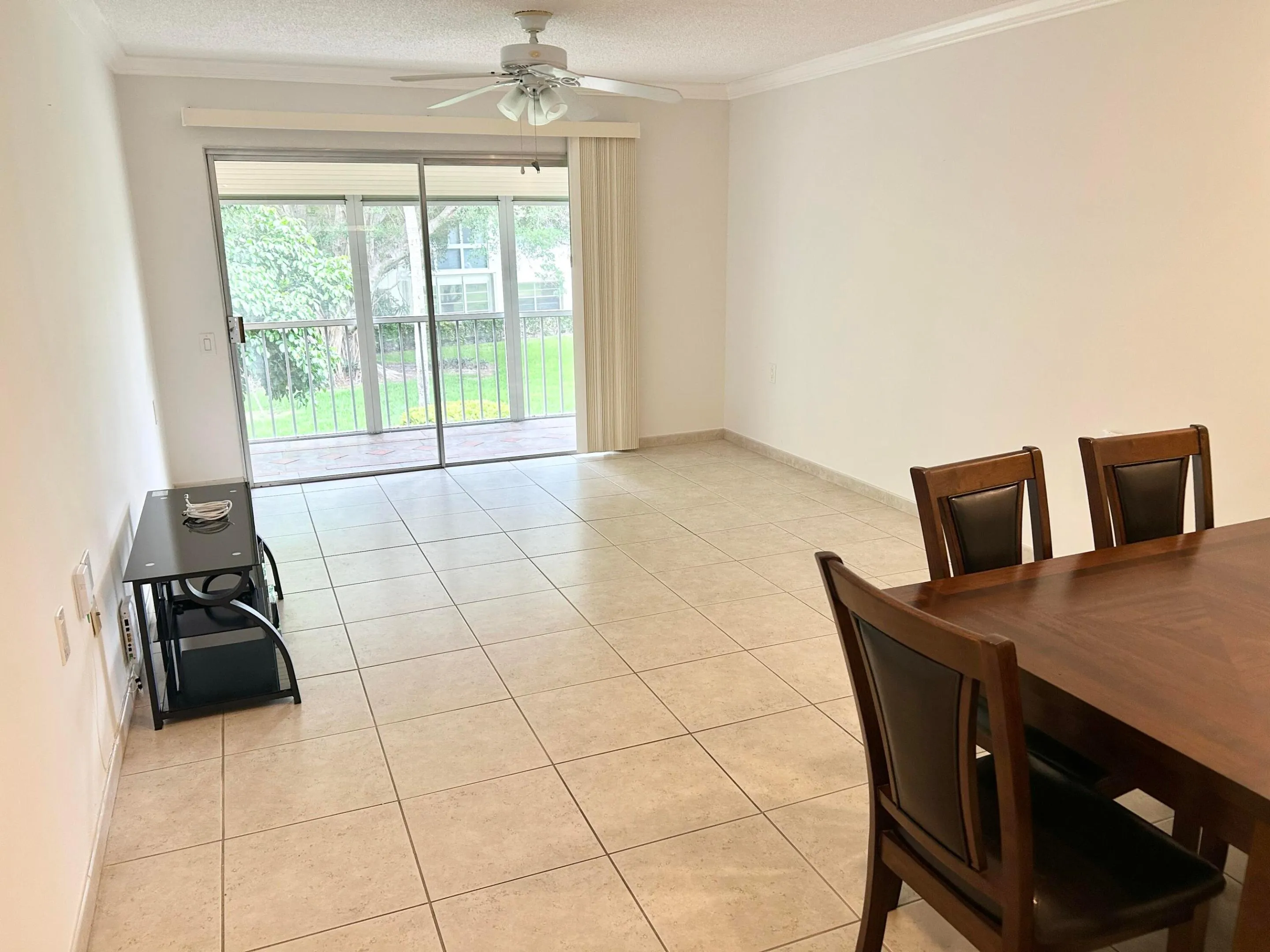 Living room with sliders leading to screened pation.