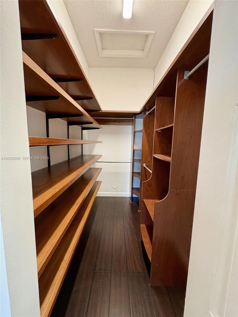 Primary bedroom walk in closet