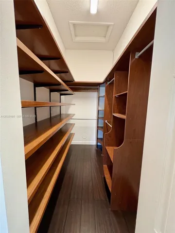 Primary bedroom walk in closet