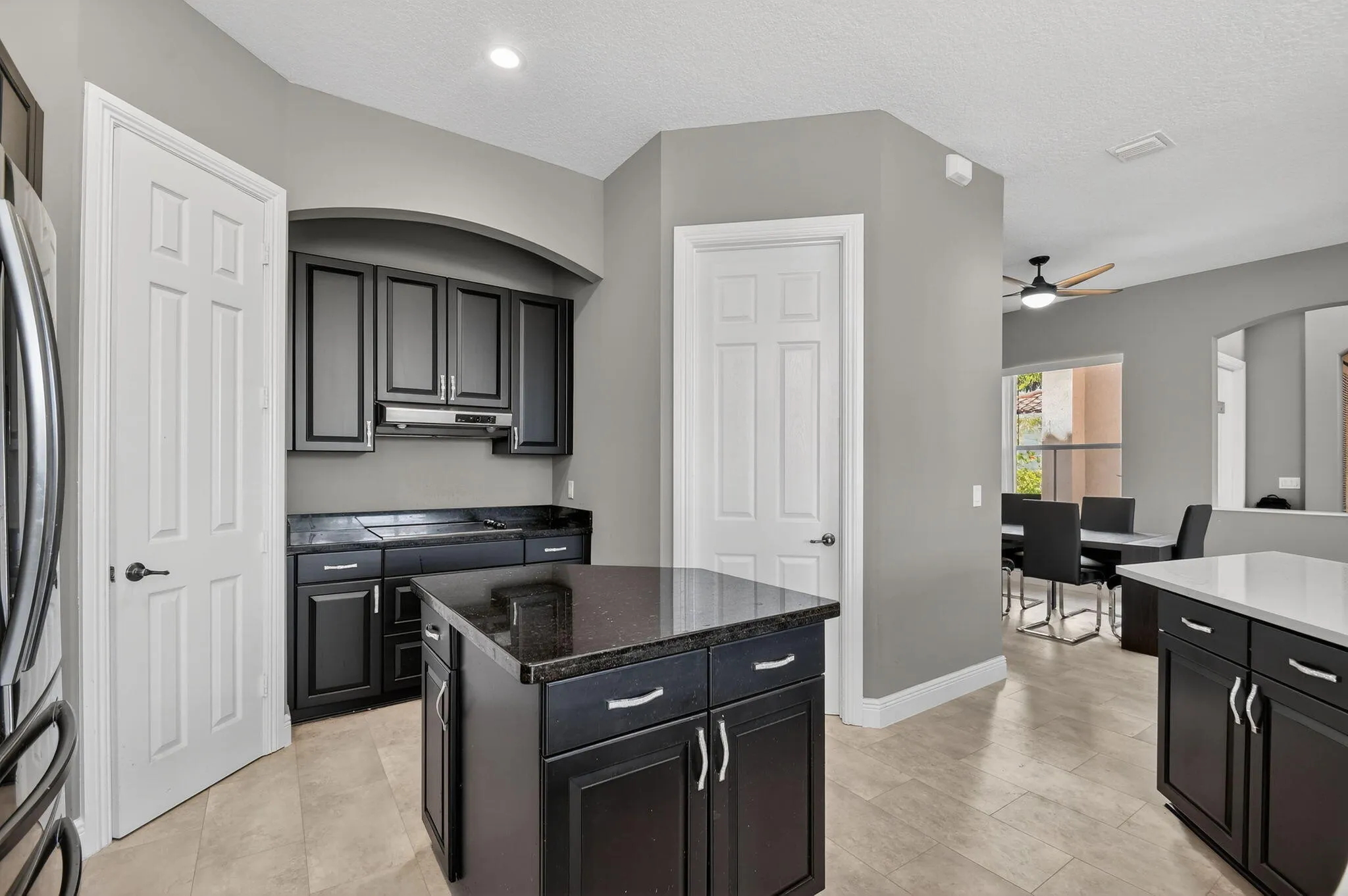 Prep island with pantry door on left and laundry room door on right, which passes through to garage