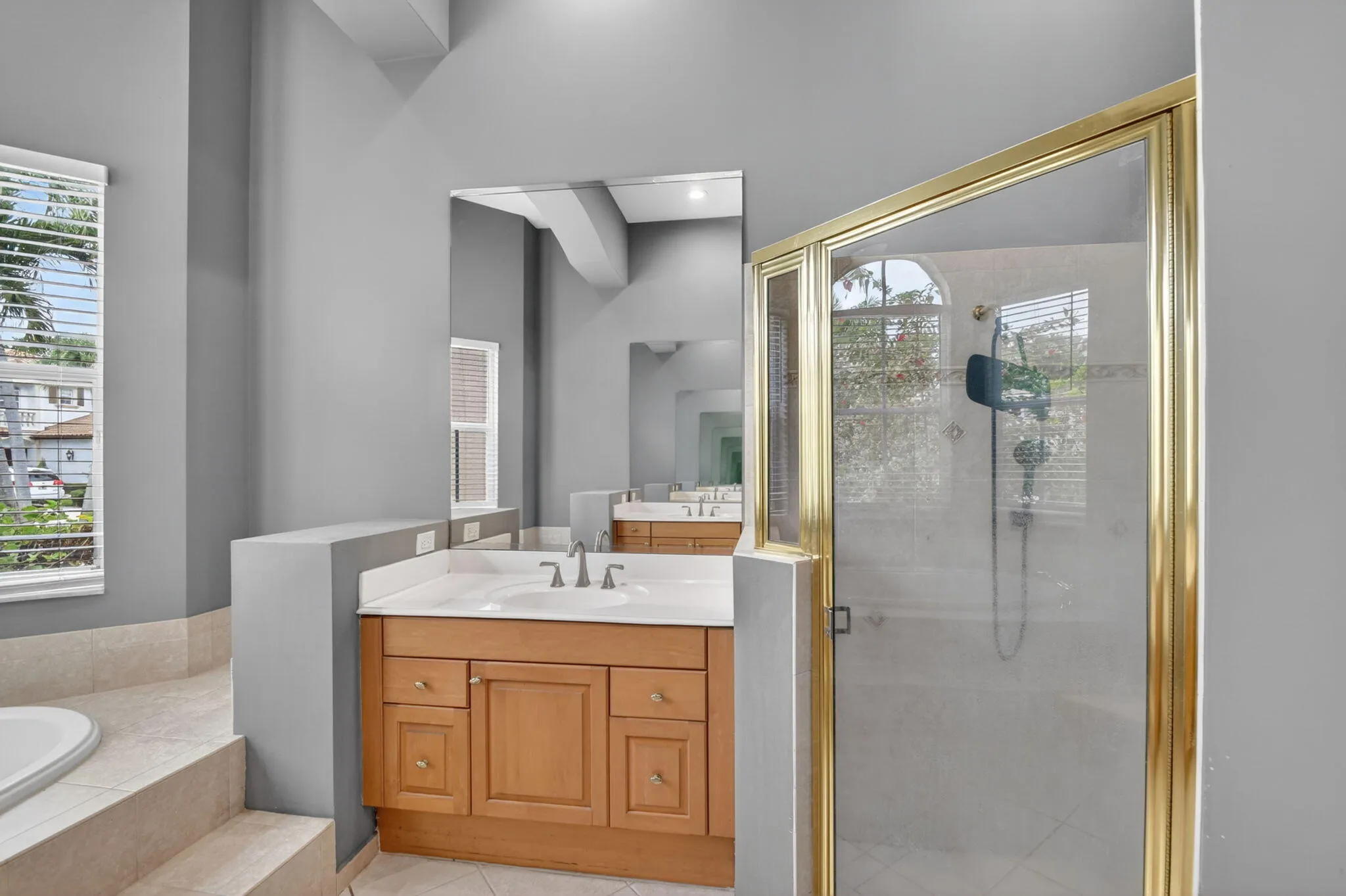 Downstairs primary bath with separate tub and shower stall