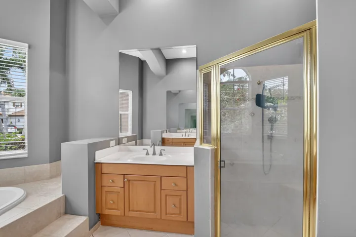 Downstairs primary bath with separate tub and shower stall